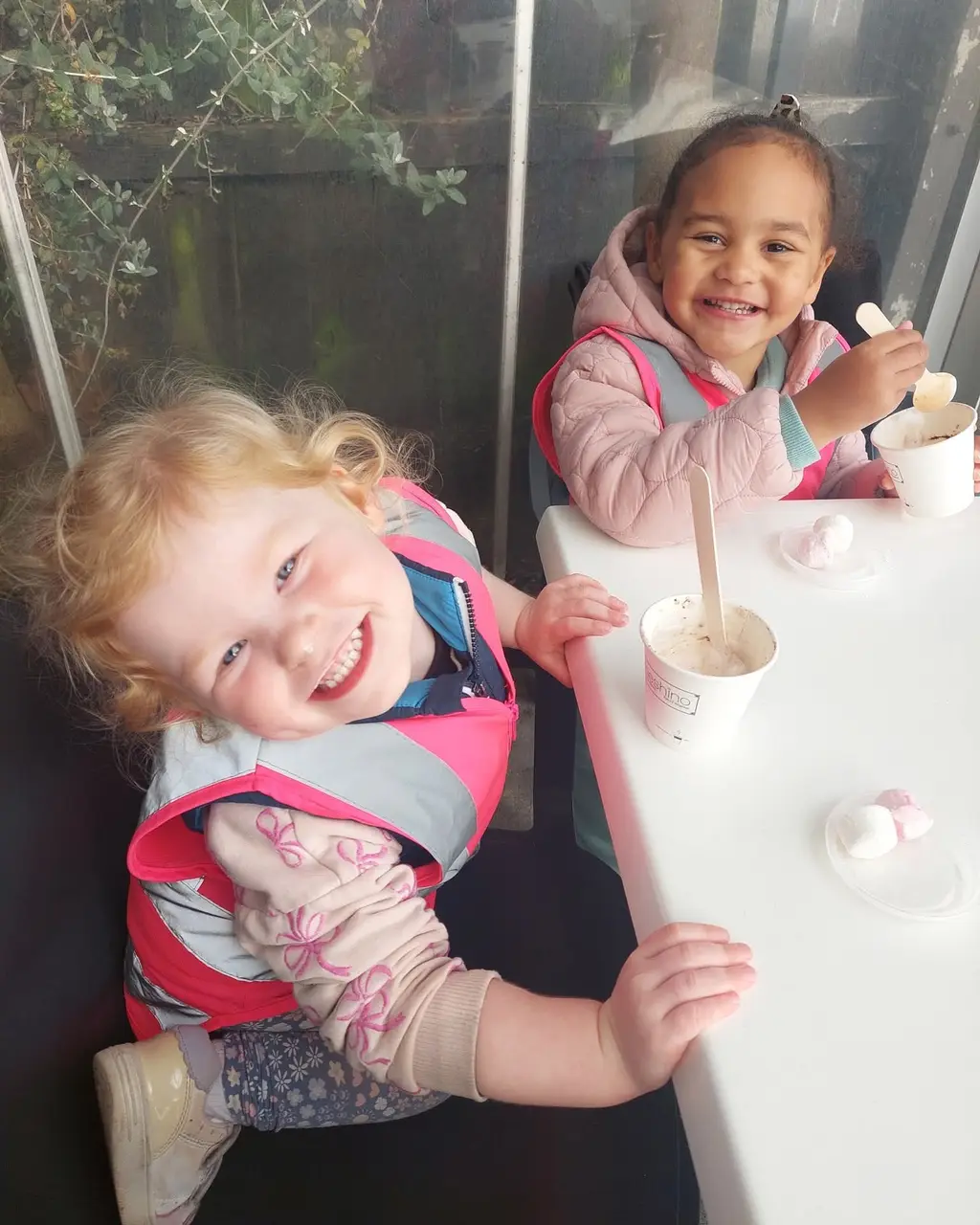 St Albans Nest toddler playing outdoors with natural loose parts
